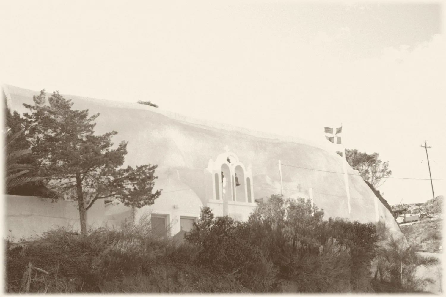 Whitewashed chapel in the Santorini landscape