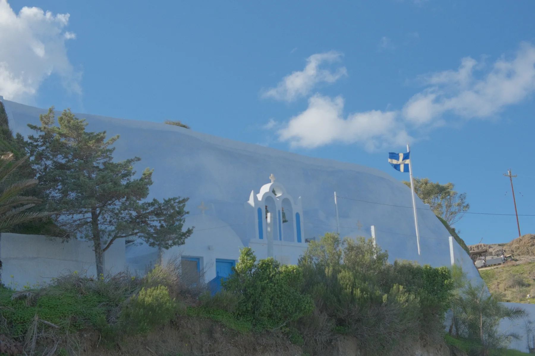 Whitewashed chapel in the Santorini landscape