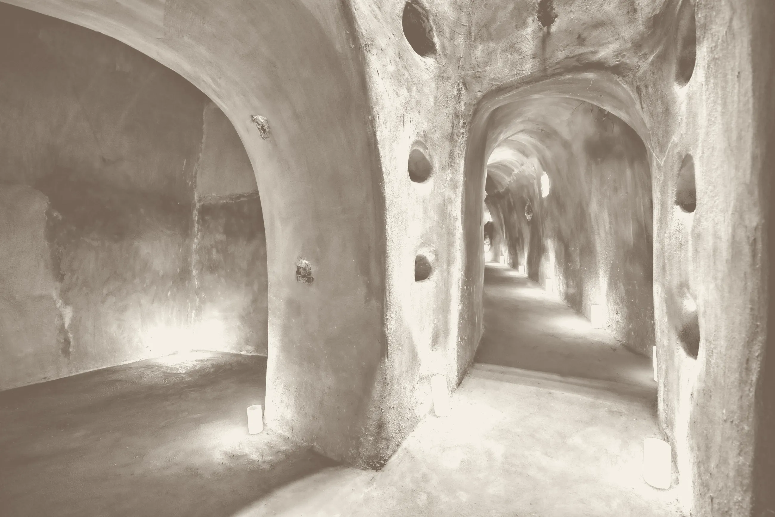 Candlelit passages carved into the volcanic rock of the Kalliston canava